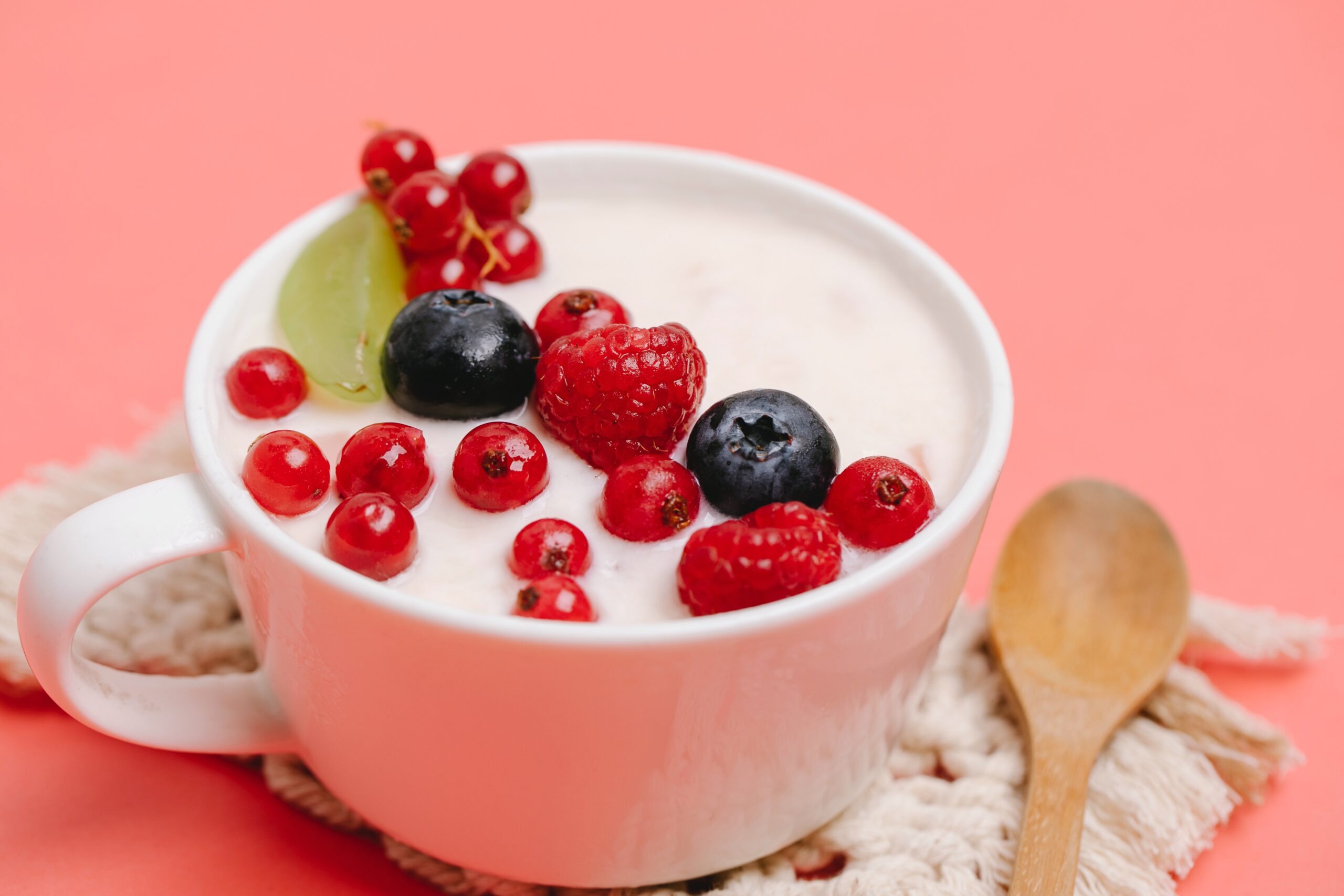 Bowl of yogurt with raspberries, blueberries, and red berries