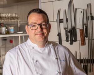 Chef Billy Wood poses for a photo in his kitchen.